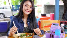 Tourist enjoying the local food, Thailand